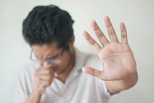 a man holding his hand up in front of his face Photo by Towfiqu barbhuiya on Unsplash